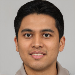 Joyful asian young-adult male with short  brown hair and brown eyes