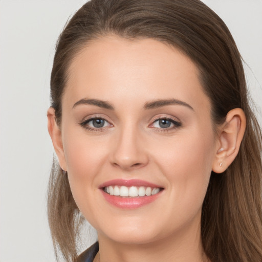 Joyful white young-adult female with long  brown hair and grey eyes