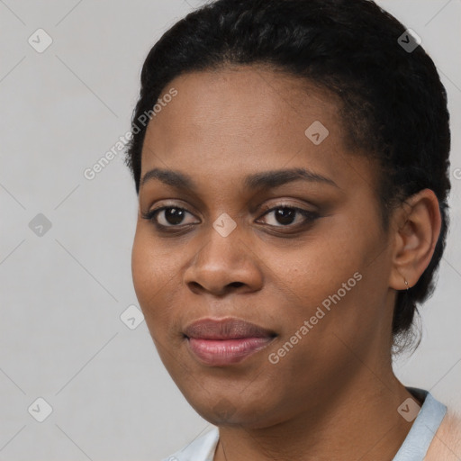 Joyful black young-adult female with short  black hair and brown eyes