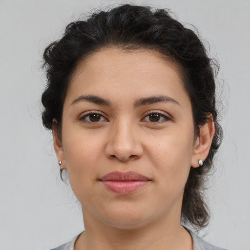 Joyful latino young-adult female with medium  brown hair and brown eyes