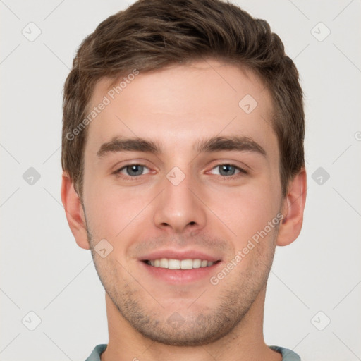 Joyful white young-adult male with short  brown hair and grey eyes