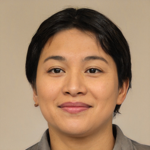 Joyful asian young-adult female with medium  brown hair and brown eyes