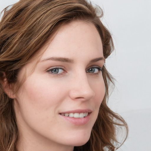 Joyful white young-adult female with long  brown hair and blue eyes