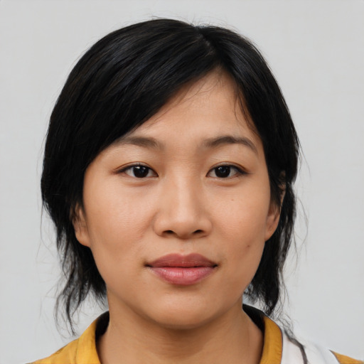 Joyful asian young-adult female with medium  black hair and brown eyes