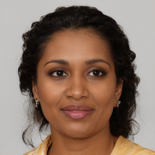 Joyful black young-adult female with medium  brown hair and brown eyes