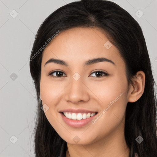 Joyful latino young-adult female with long  brown hair and brown eyes