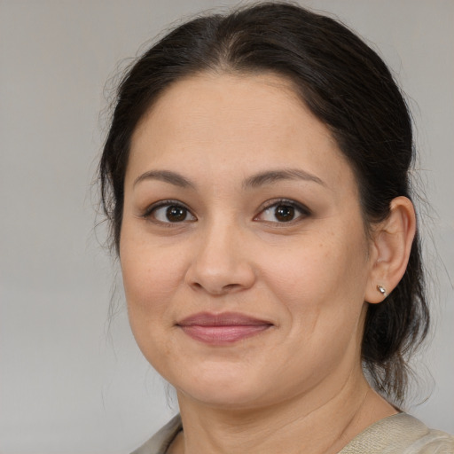 Joyful white adult female with medium  brown hair and brown eyes