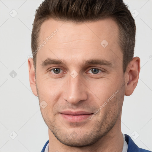 Joyful white young-adult male with short  brown hair and brown eyes