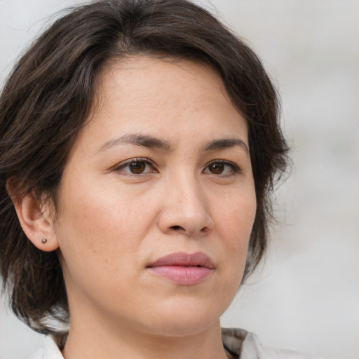 Joyful white adult female with medium  brown hair and brown eyes