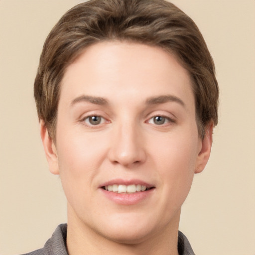 Joyful white young-adult female with short  brown hair and grey eyes