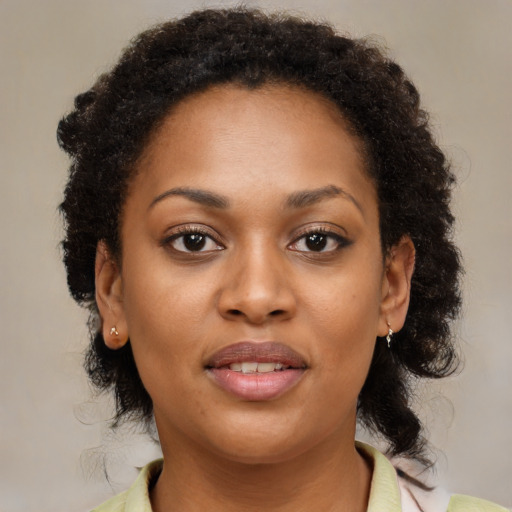 Joyful black young-adult female with medium  brown hair and brown eyes