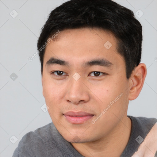 Joyful asian young-adult male with short  black hair and brown eyes