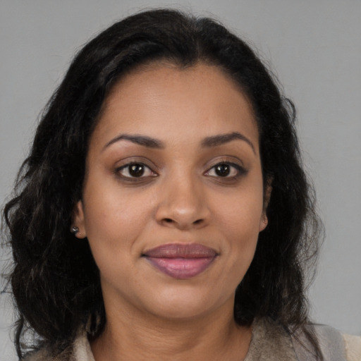 Joyful black young-adult female with medium  brown hair and brown eyes