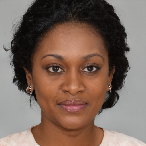 Joyful black young-adult female with medium  brown hair and brown eyes