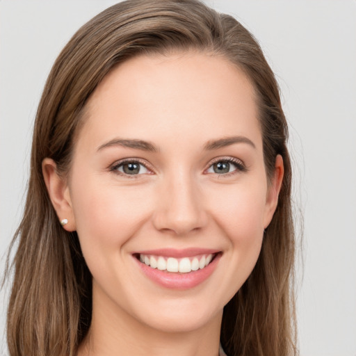 Joyful white young-adult female with long  brown hair and grey eyes