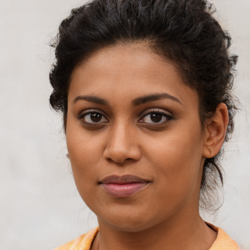 Joyful latino young-adult female with medium  brown hair and brown eyes