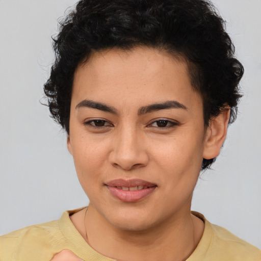 Joyful latino young-adult female with short  brown hair and brown eyes