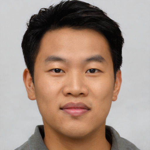 Joyful asian young-adult male with short  black hair and brown eyes