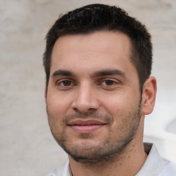 Joyful white young-adult male with short  black hair and brown eyes