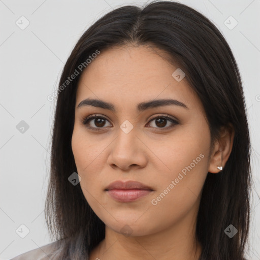 Joyful latino young-adult female with long  brown hair and brown eyes