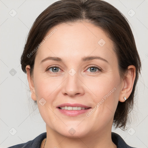 Joyful white adult female with medium  brown hair and grey eyes