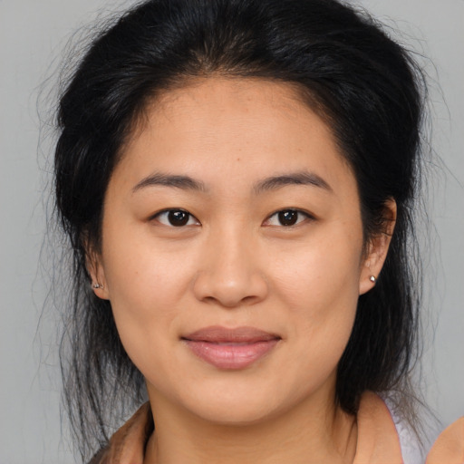 Joyful asian young-adult female with medium  brown hair and brown eyes