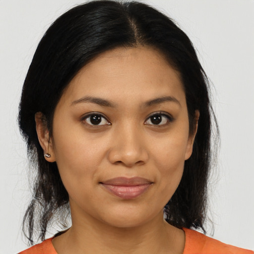 Joyful latino young-adult female with medium  brown hair and brown eyes