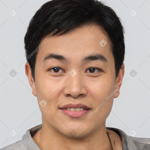 Joyful asian young-adult male with short  brown hair and brown eyes