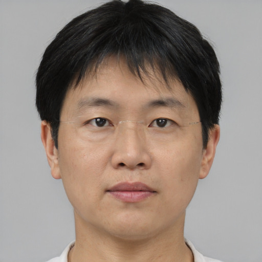 Neutral asian adult male with short  brown hair and brown eyes