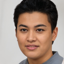 Joyful asian young-adult male with short  brown hair and brown eyes