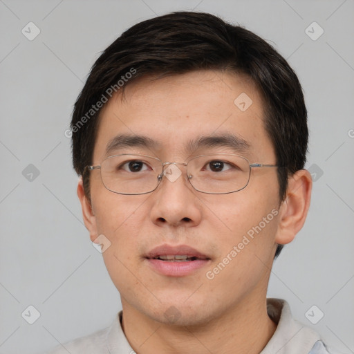 Joyful white adult male with short  black hair and brown eyes