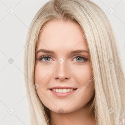 Joyful white young-adult female with long  brown hair and blue eyes