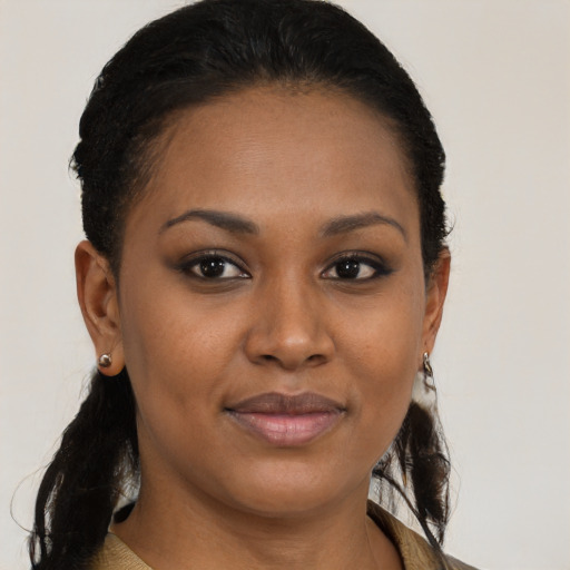 Joyful black young-adult female with medium  brown hair and brown eyes