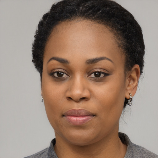 Joyful black young-adult female with short  black hair and brown eyes