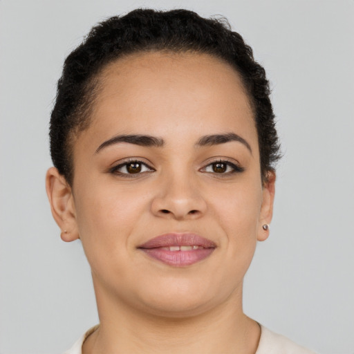 Joyful latino young-adult female with short  brown hair and brown eyes