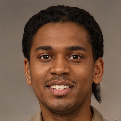 Joyful black young-adult male with short  black hair and brown eyes