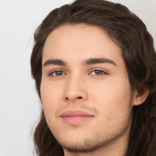 Neutral white young-adult male with long  brown hair and brown eyes