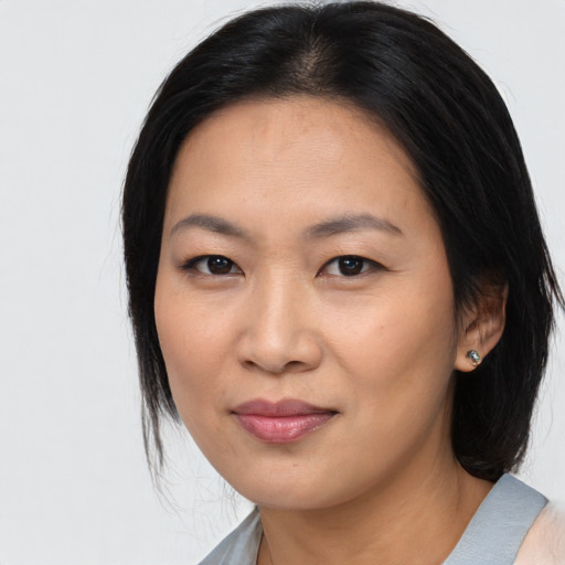 Joyful asian young-adult female with medium  black hair and brown eyes