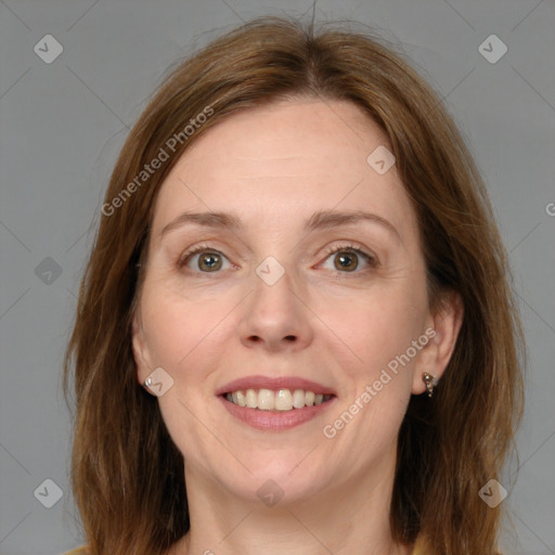 Joyful white adult female with medium  brown hair and grey eyes