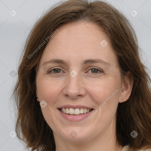 Joyful white adult female with long  brown hair and brown eyes