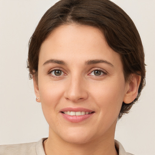 Joyful white young-adult female with short  brown hair and brown eyes