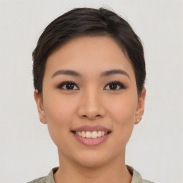 Joyful asian young-adult female with short  brown hair and brown eyes