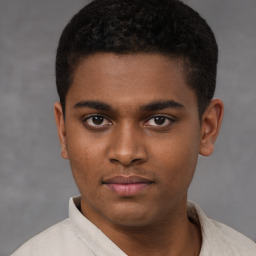 Joyful latino young-adult male with short  brown hair and brown eyes