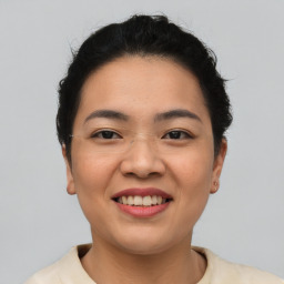 Joyful asian young-adult female with short  brown hair and brown eyes