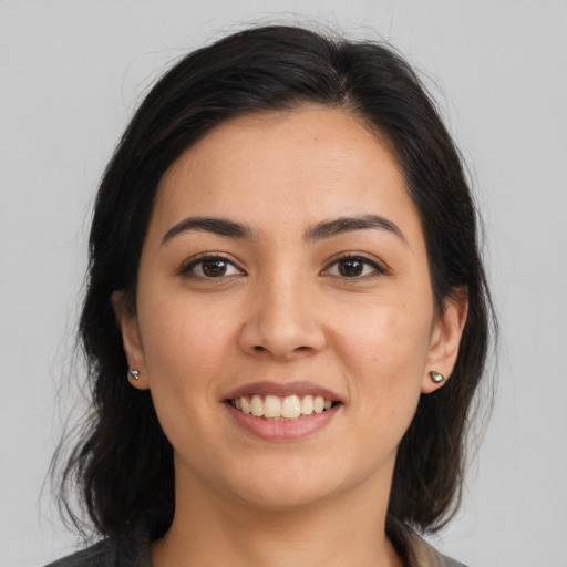 Joyful latino young-adult female with medium  brown hair and brown eyes