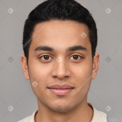 Joyful latino young-adult male with short  black hair and brown eyes