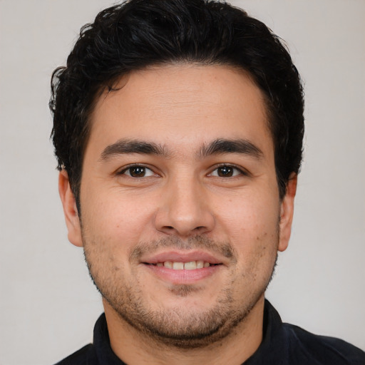 Joyful white young-adult male with short  black hair and brown eyes