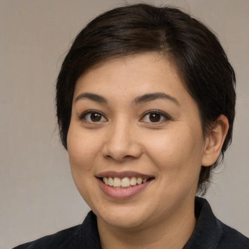 Joyful asian young-adult female with medium  brown hair and brown eyes