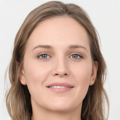 Joyful white young-adult female with long  brown hair and grey eyes