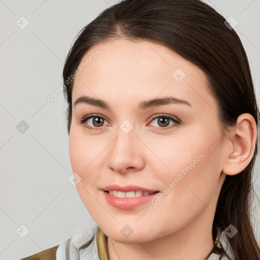 Joyful white young-adult female with long  brown hair and brown eyes